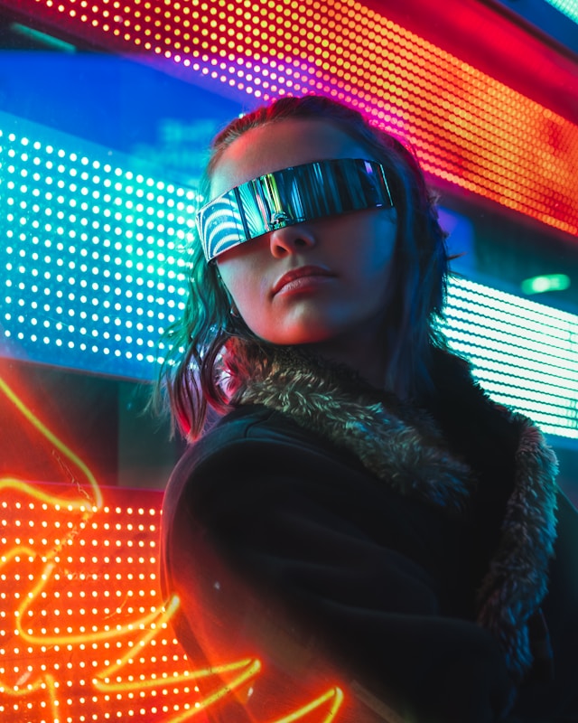 Portrait in neon light, chrome visor and fur collar